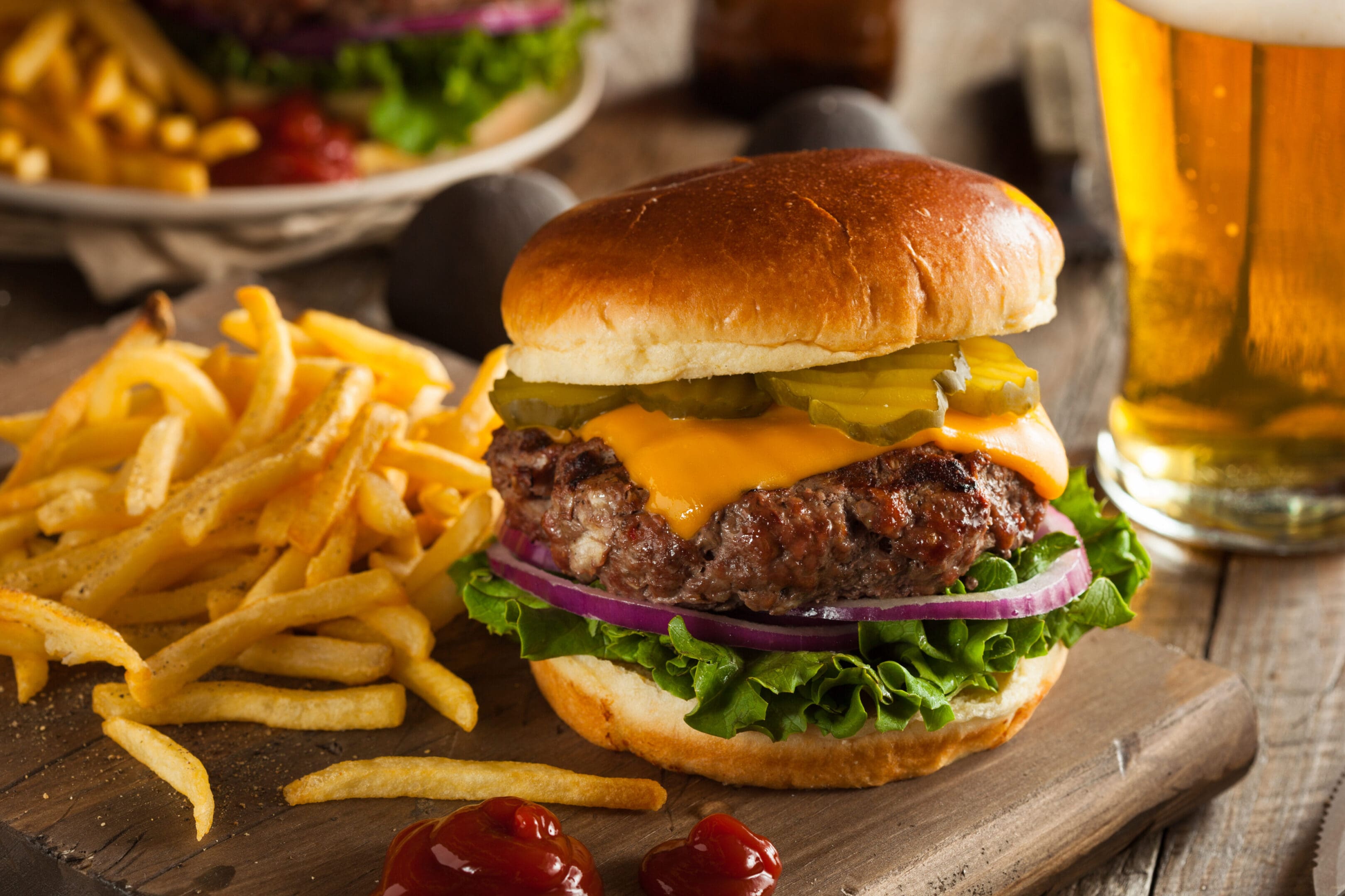 A hamburger and french fries on a table.